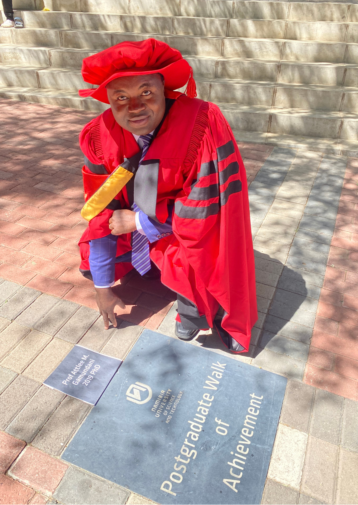 Prof Attlee Gamundani, posing at the Postgraduate Walk of Achievement site. He obtained a Doctoral qualification in Computer Science in 2019, from the Faculty of Computing and Informatics, and is amongst the first PhD graduates from the Institution.  