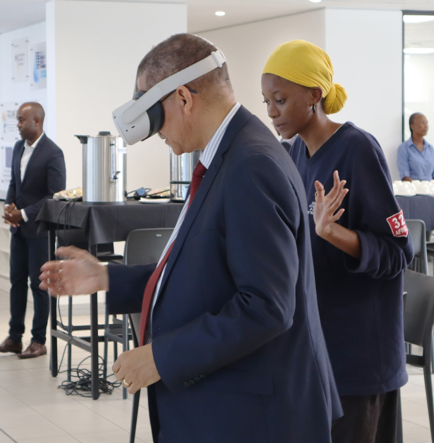 Deputy Executive Director for the Lifelong Learning Department from the Ministry of Education, Arts and Culture (left) enjoying a virtual reality experience guided by Selma Auala, a student from the Faculty of Computing and Informatics.