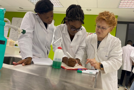 Dr Corinne Ganetenbein taking a moment to share insights with two students during a laboratory practical session